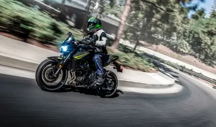 A motorcyclist rides a sport bike on a curving road